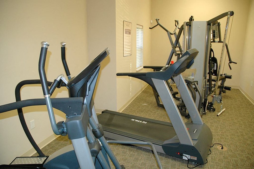 a gym with several pieces of exercise equipment