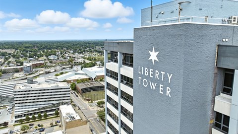 A tall building with a white star and the words "Liberty Tower" on it.