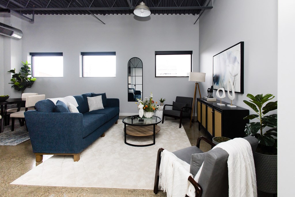 a living room with a blue couch and a table