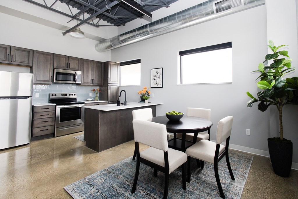a kitchen and dining room with a table and chairs