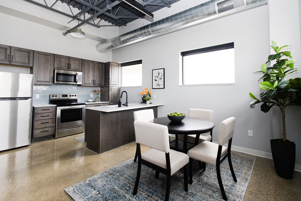 a kitchen and dining room with a table and chairs