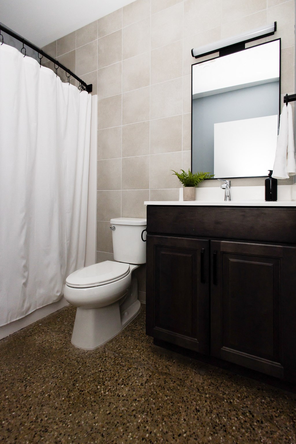 a bathroom with a toilet and a sink and a shower curtain