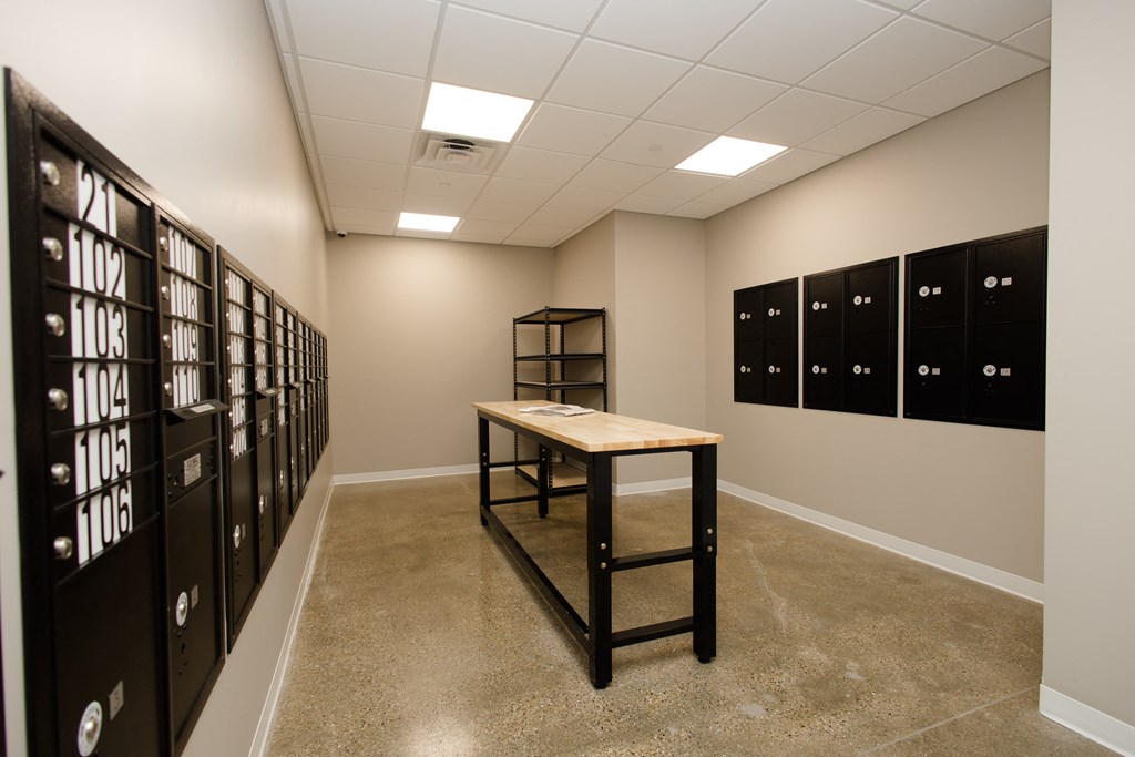 a room with lockers and a table in the middle
