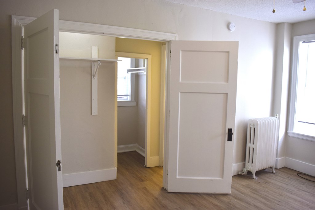 A room with a white door and a window.