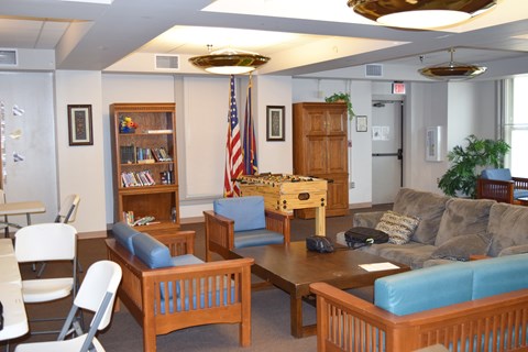 A living room with a couch, chairs, and a coffee table.