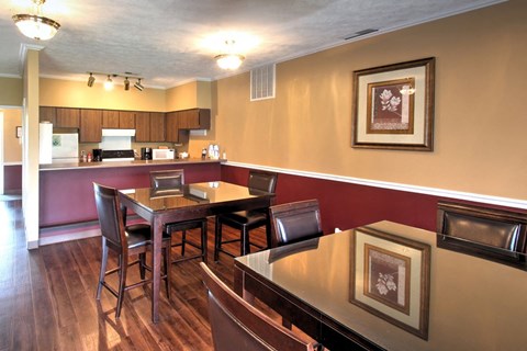 a dining room and kitchen with a table and chairs