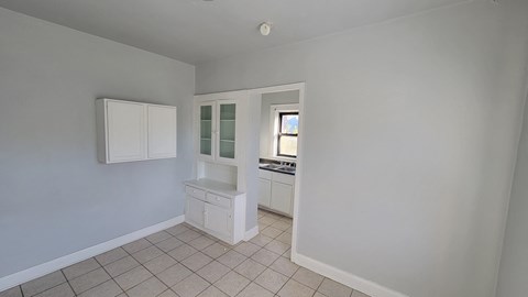 a small kitchen with a white cabinet and a sink