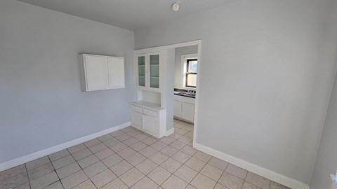 an empty kitchen with a cabinet and a sink