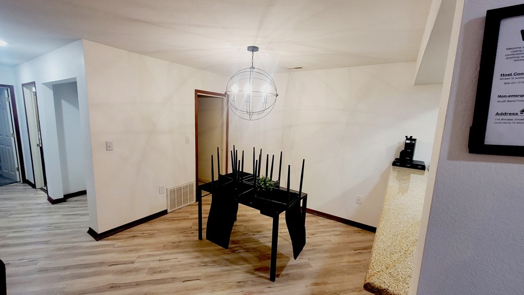 A room with a table and chairs in it.