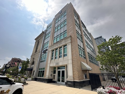 a tall building with a car parked in front of it