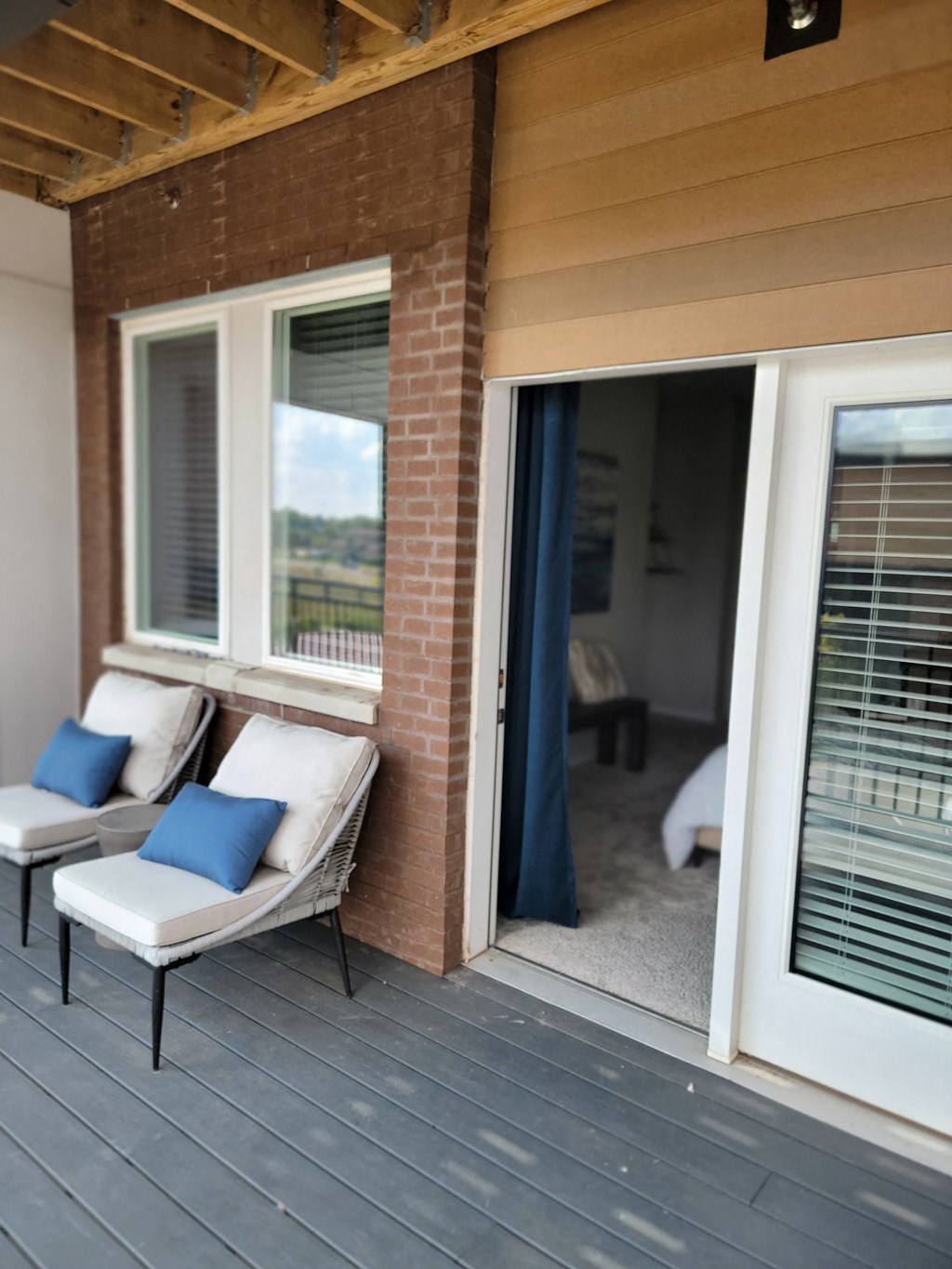 a porch with two chairs and a sliding glass door