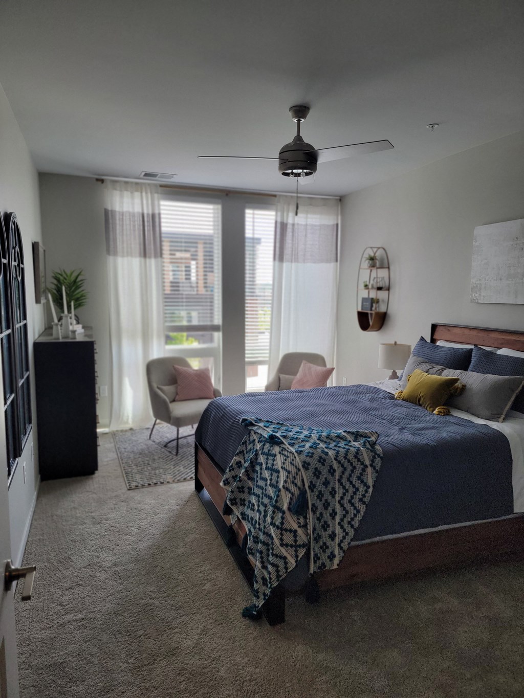 a master bedroom with a large bed and a large window