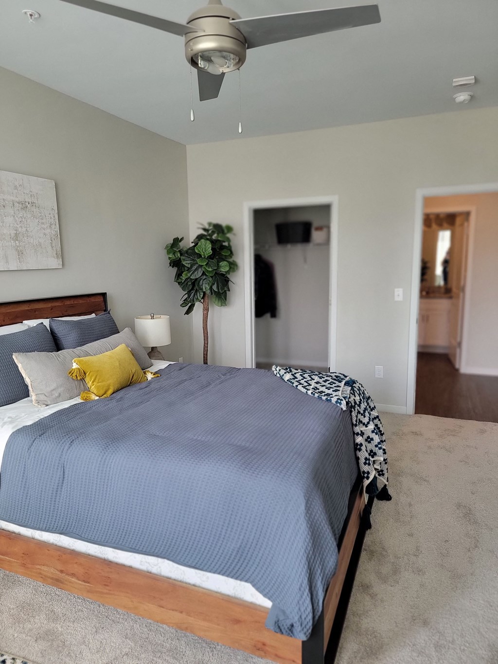 a bedroom with a bed and a ceiling fan