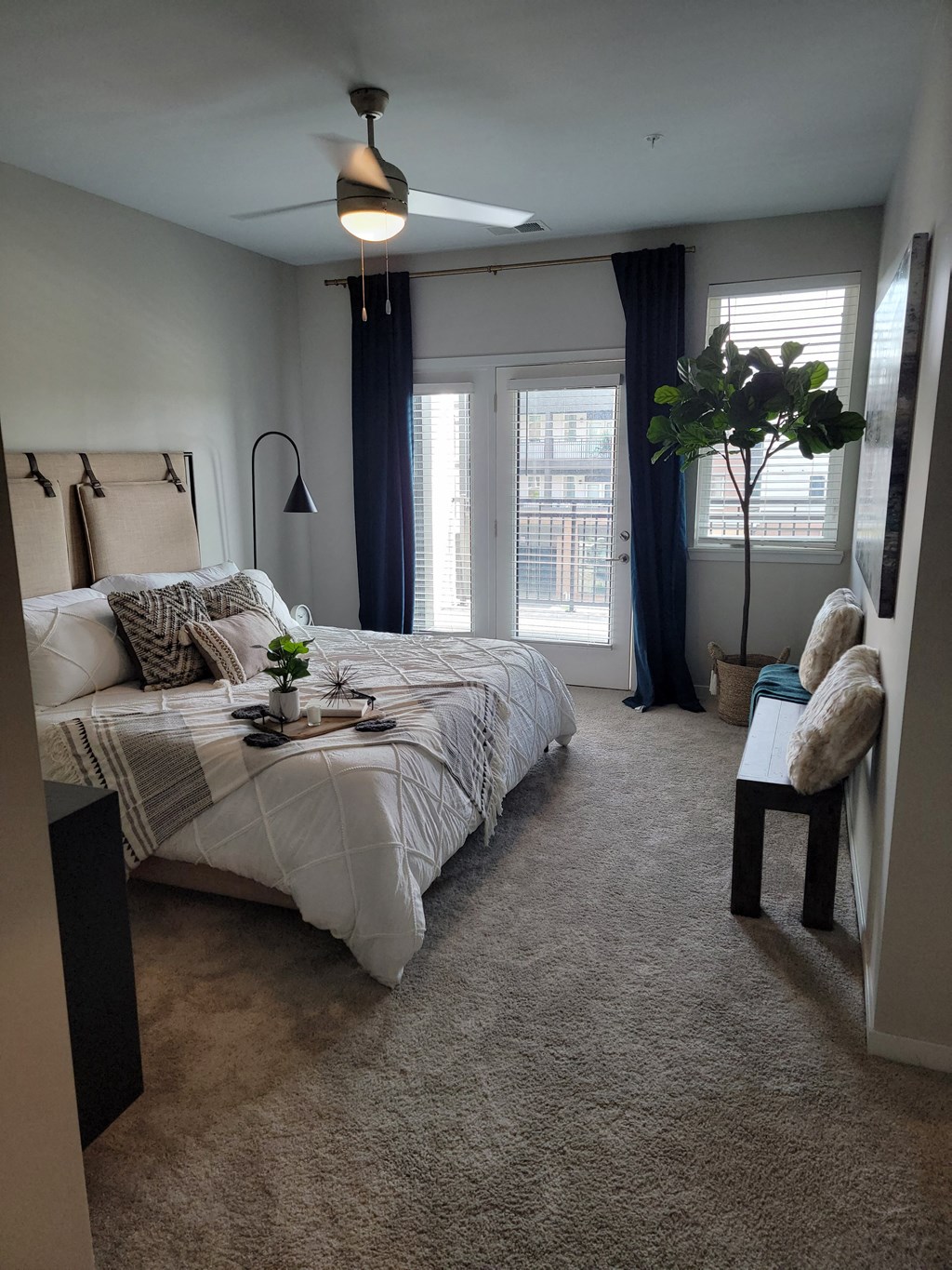 a bedroom with a bed and a window with curtains