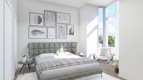 a bedroom with a bed and a chair in front of a window