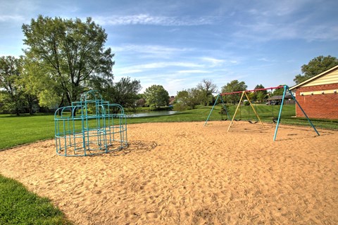a playground with a swing set in a park
