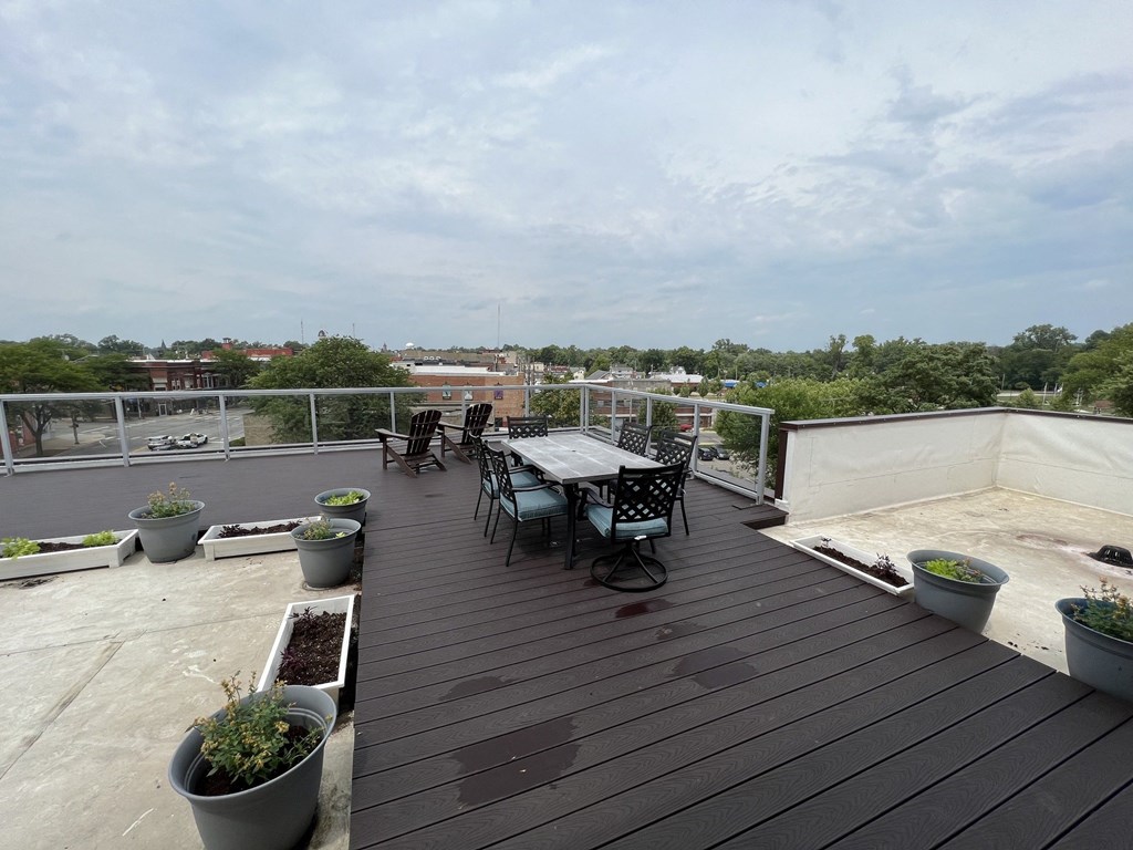 a patio with a table and chairs on a roof