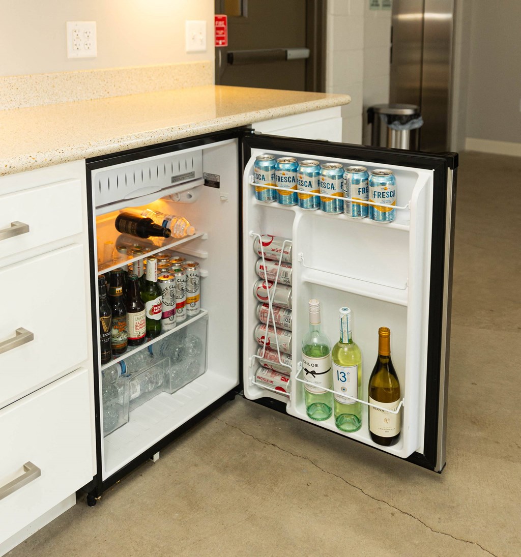 an open refrigerator in a kitchen with a counter top