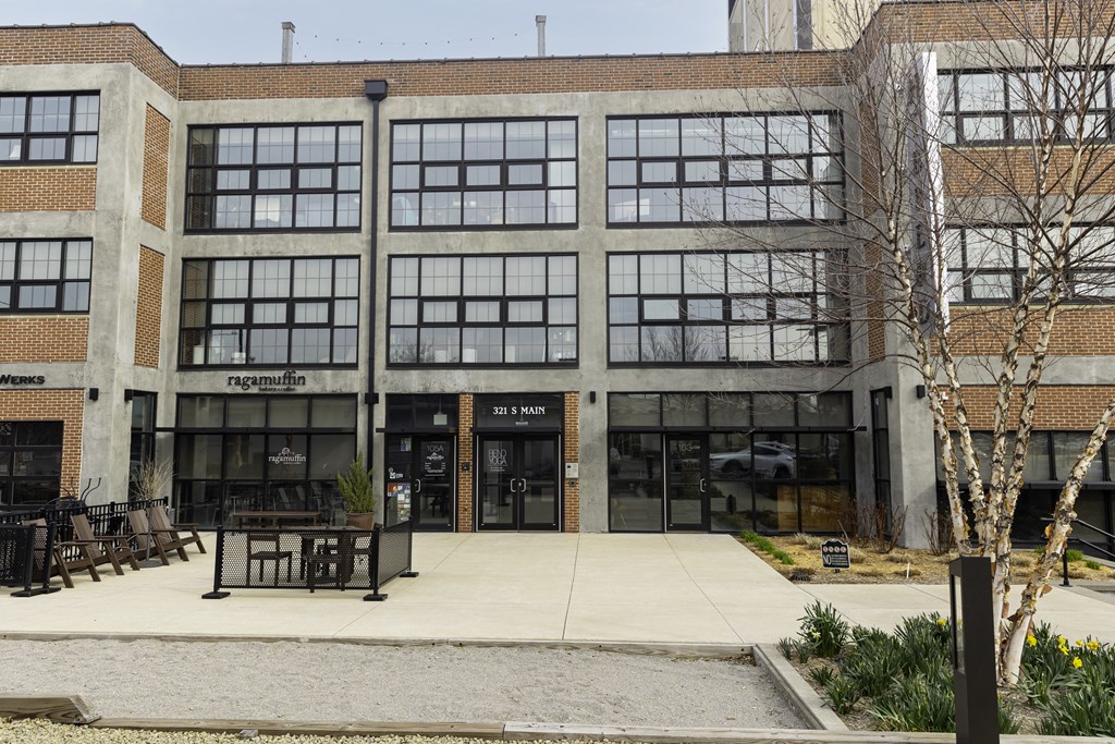 a large building with a sidewalk in front of it