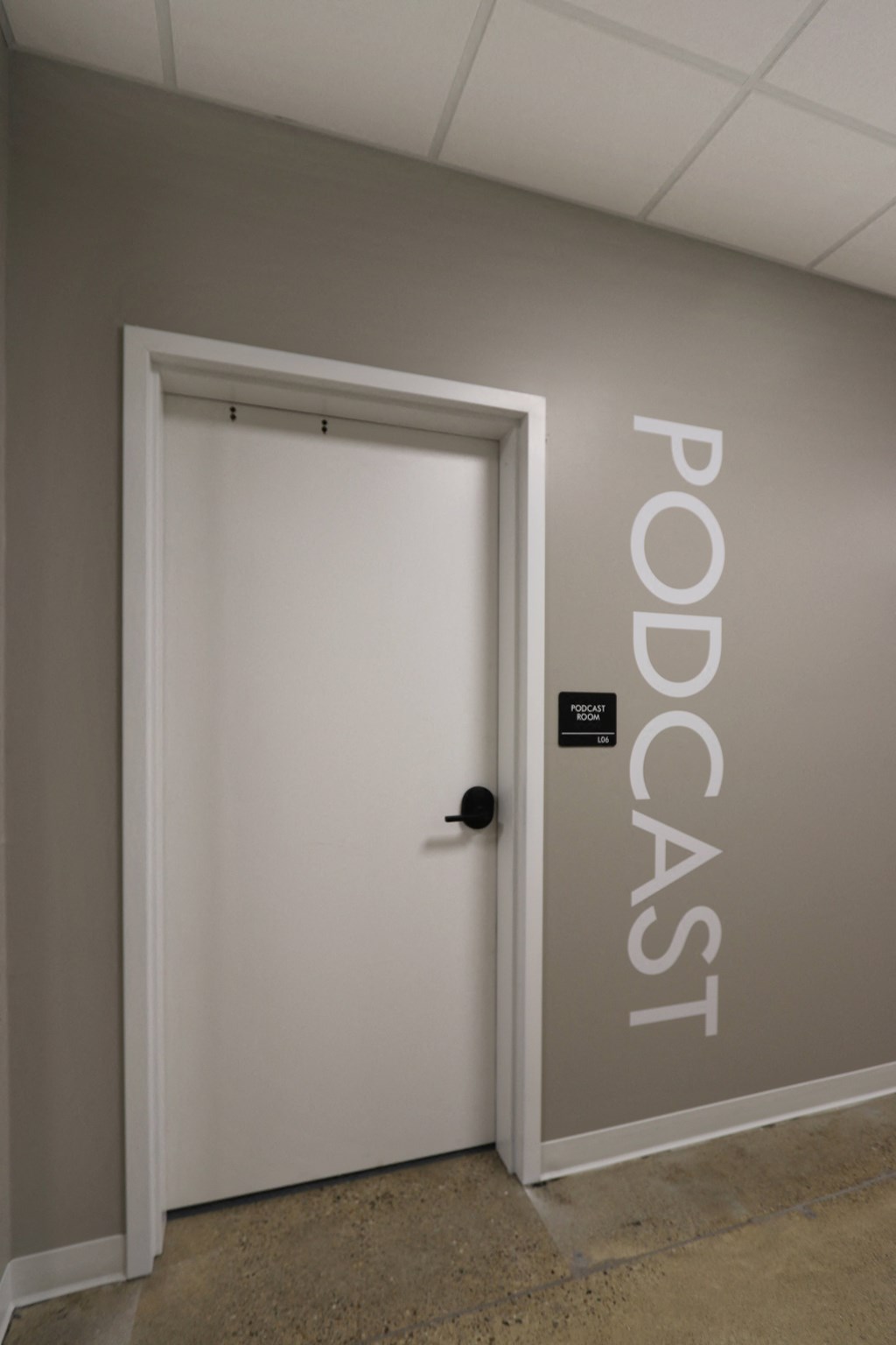 a white door in a hallway with a black door knob