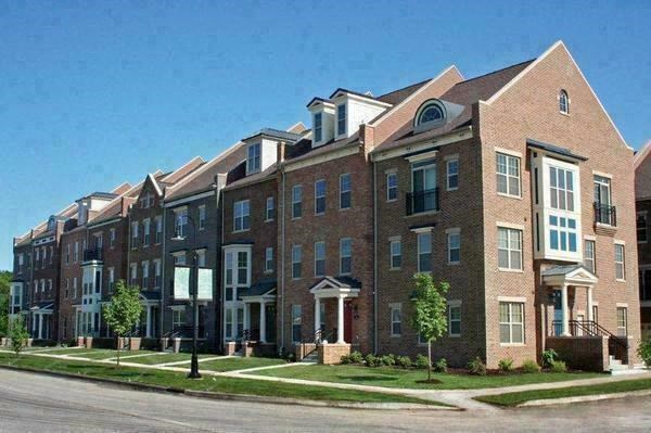 a large brick apartment building on the side of a street