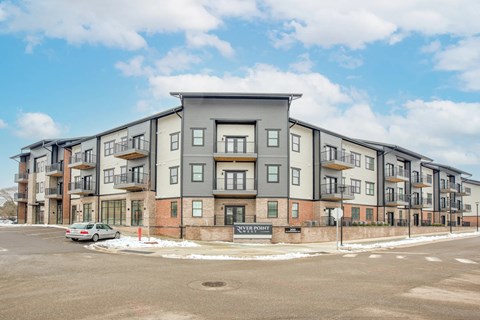 an apartment building with a car parked in front of it