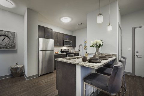 a kitchen with stainless steel appliances and a granite counter top