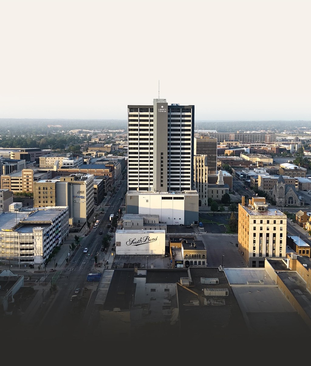 A cityscape with a tall building in the center and a sign that reads "St. Regis".