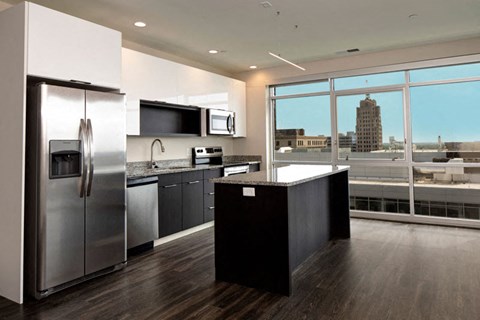 a kitchen with stainless steel appliances and a large window