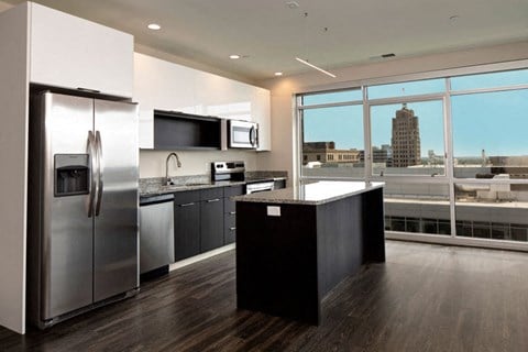 a kitchen with stainless steel appliances and a large window