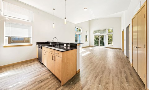 a kitchen with a sink and a counter top in the middle of a room