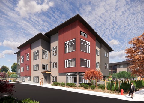 A red and grey apartment building with the number 1060 on the front.