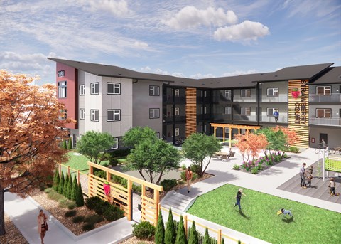 A modern apartment complex with a playground and greenery.