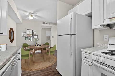 A kitchen with a table and chairs in the middle of the room.