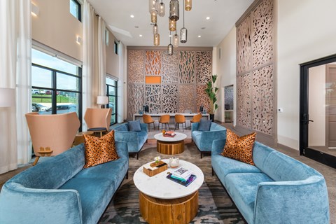 A living room with blue couches and a wooden coffee table.
