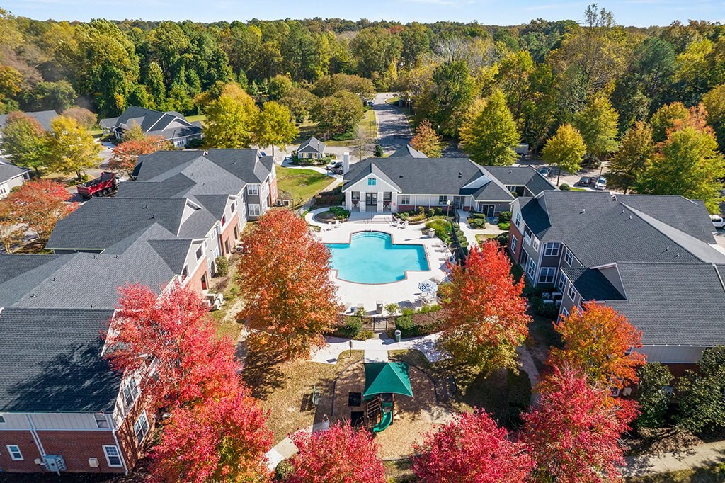 Aerial view of pool with trees surrounding at Grand Oaks in Chester VA