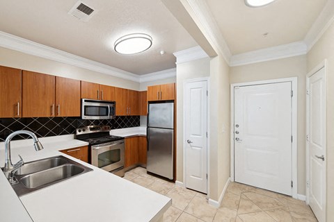 a kitchen with stainless steel appliances and white counter tops