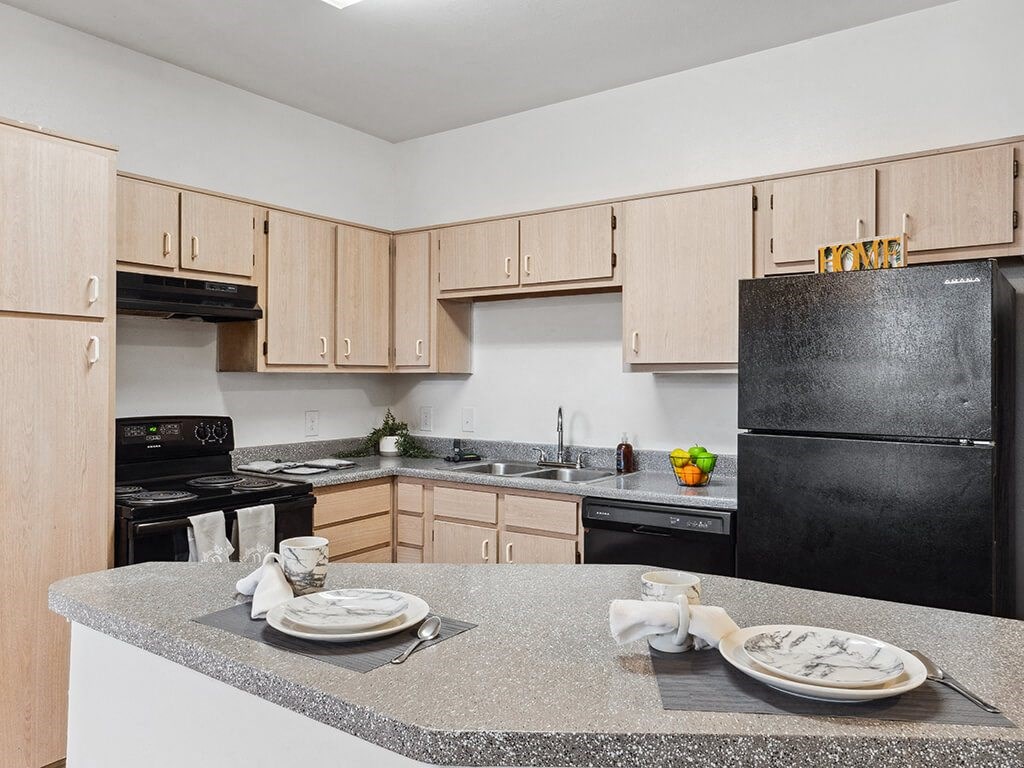 Kitchen with black appliances at Tidwell Estates in Houston TX