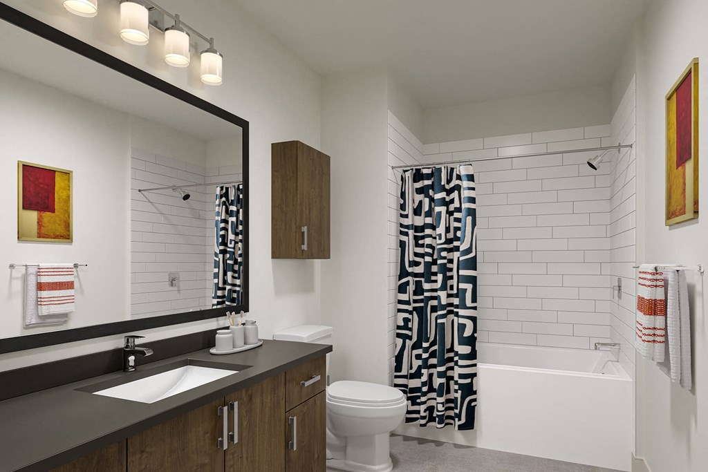 a bathroom with a toilet sink and bathtub in a 555 waverly unit