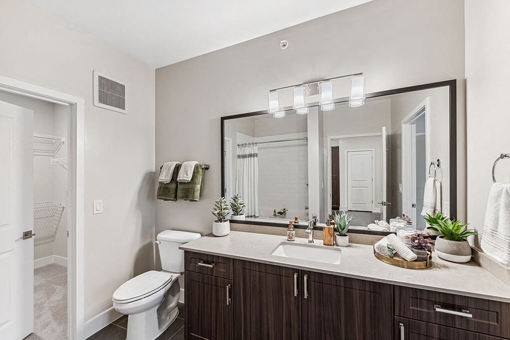 Bathroom with large mirror at The Moxley in Fairfax VA