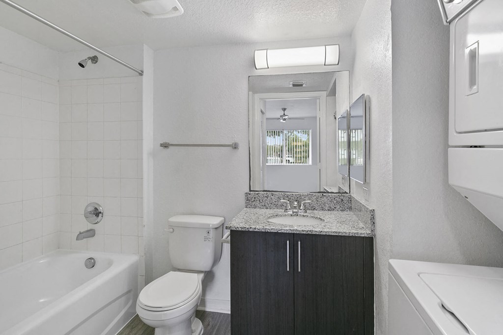 Bathroom with in unit laundry at Brenton at Abbey Park Apartments in West Palm Beach FL