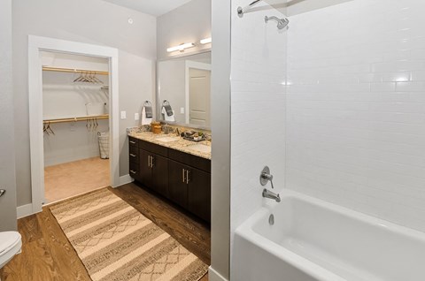 Bathroom with attached walk in closet at Opal Legacy Central in Plano TX