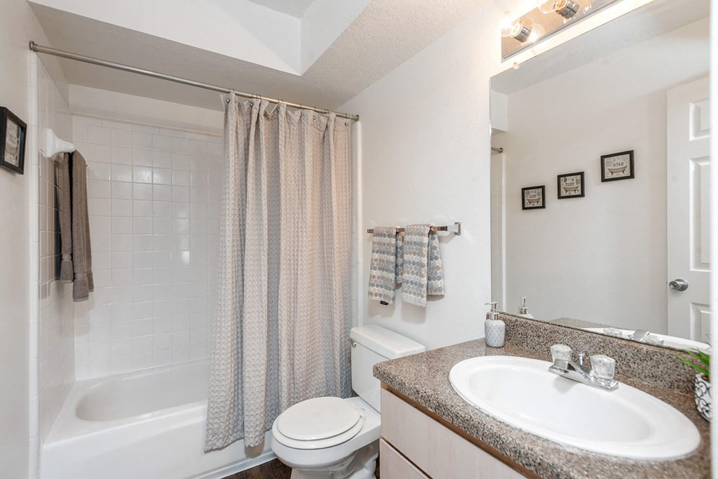 Bathroom with sink and shower at Park Village Apartments in Conroe TX