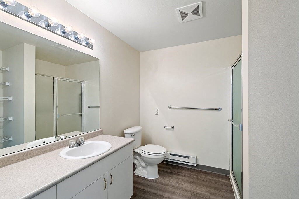 a bathroom with a toilet sink and shower