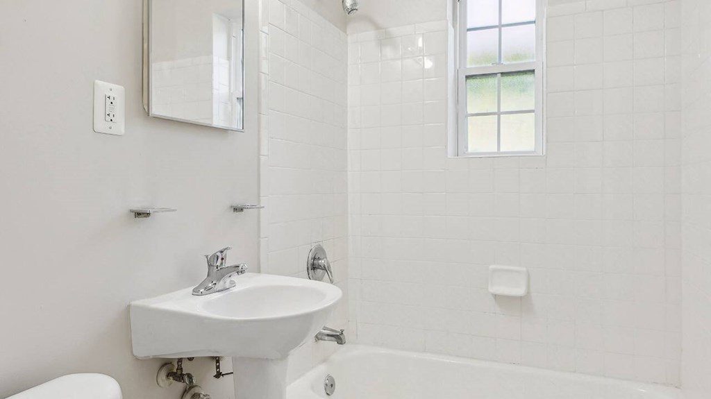 White bathroom with sink at The Barrington in Silver Spring MD