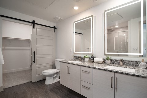 Bathroom with double sinks and closet at District at Scottsdale Apartments in Scottsdale AZ