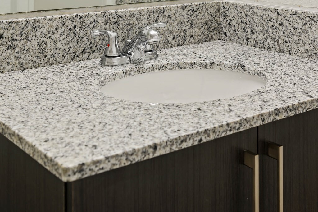 Granite bathroom vanity at Brenton at Abbey Park Apartments in West Palm Beach FL
