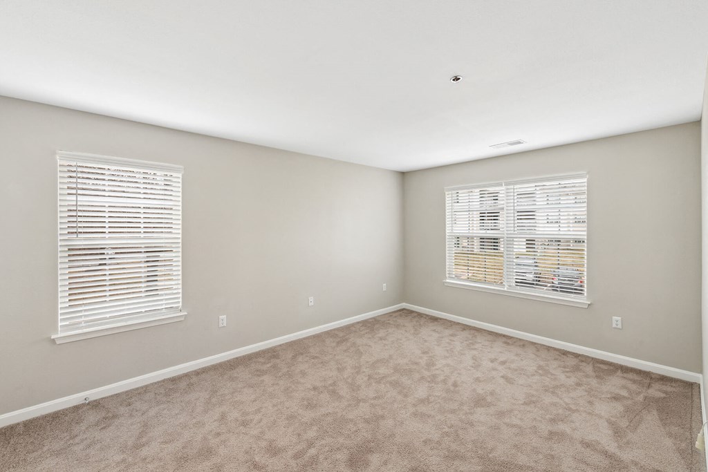 Bedroom with large windows at England Run Apartments in Fredericksburg VA