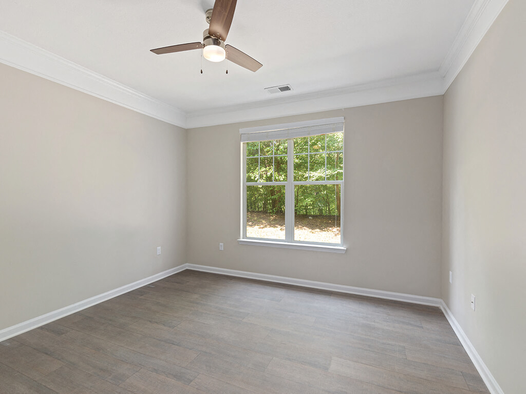 Bedroom with natural light and ceiling fan at Falls Pointe Apartments in Durham NC