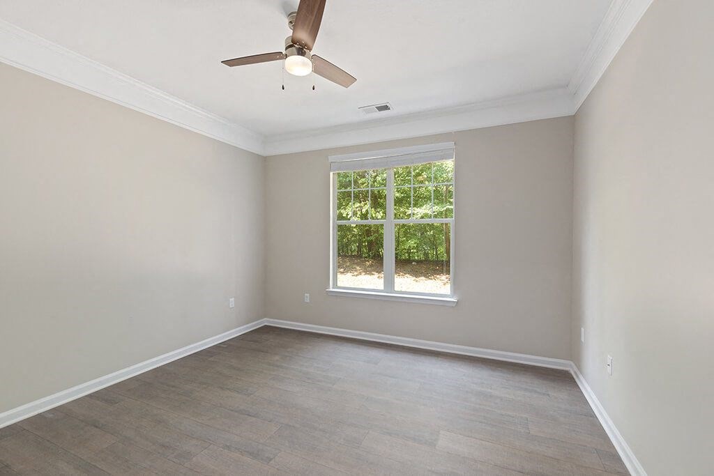Bedroom with window at Falls Pointe at the Park Apartments in Durham NC